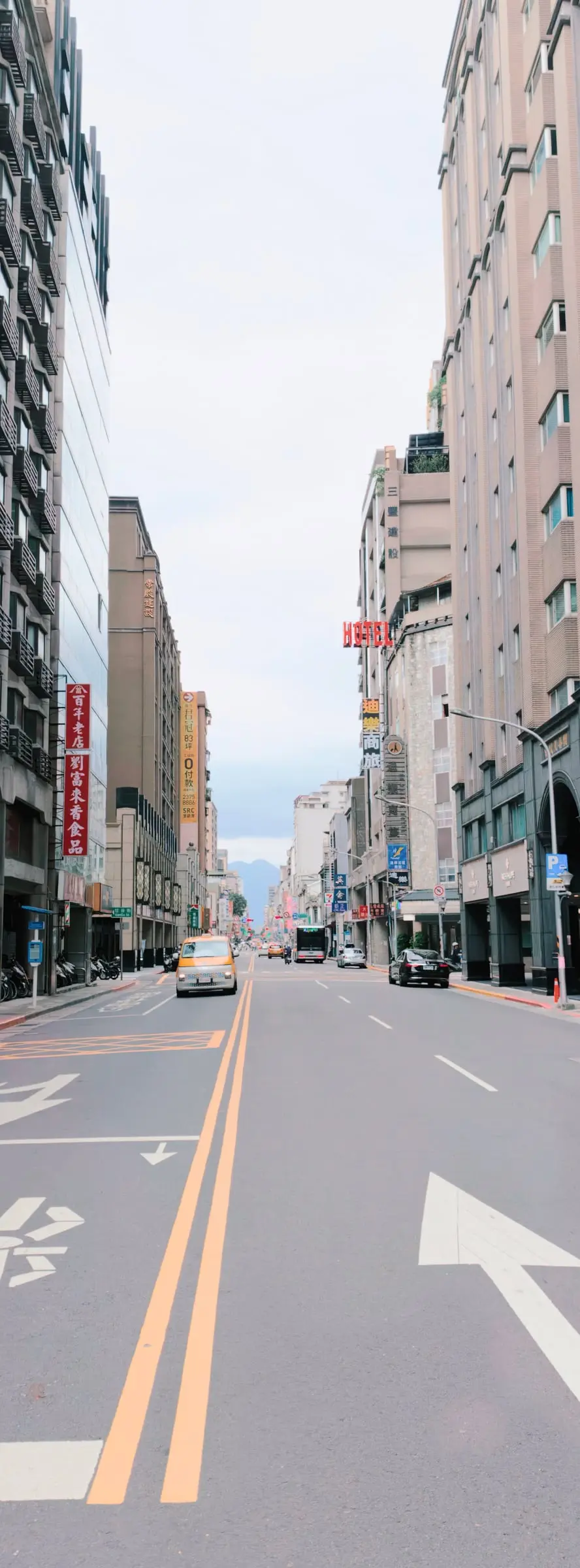 A vertical view along Chang'an West Road in Taipei, framed by buildings and road markings