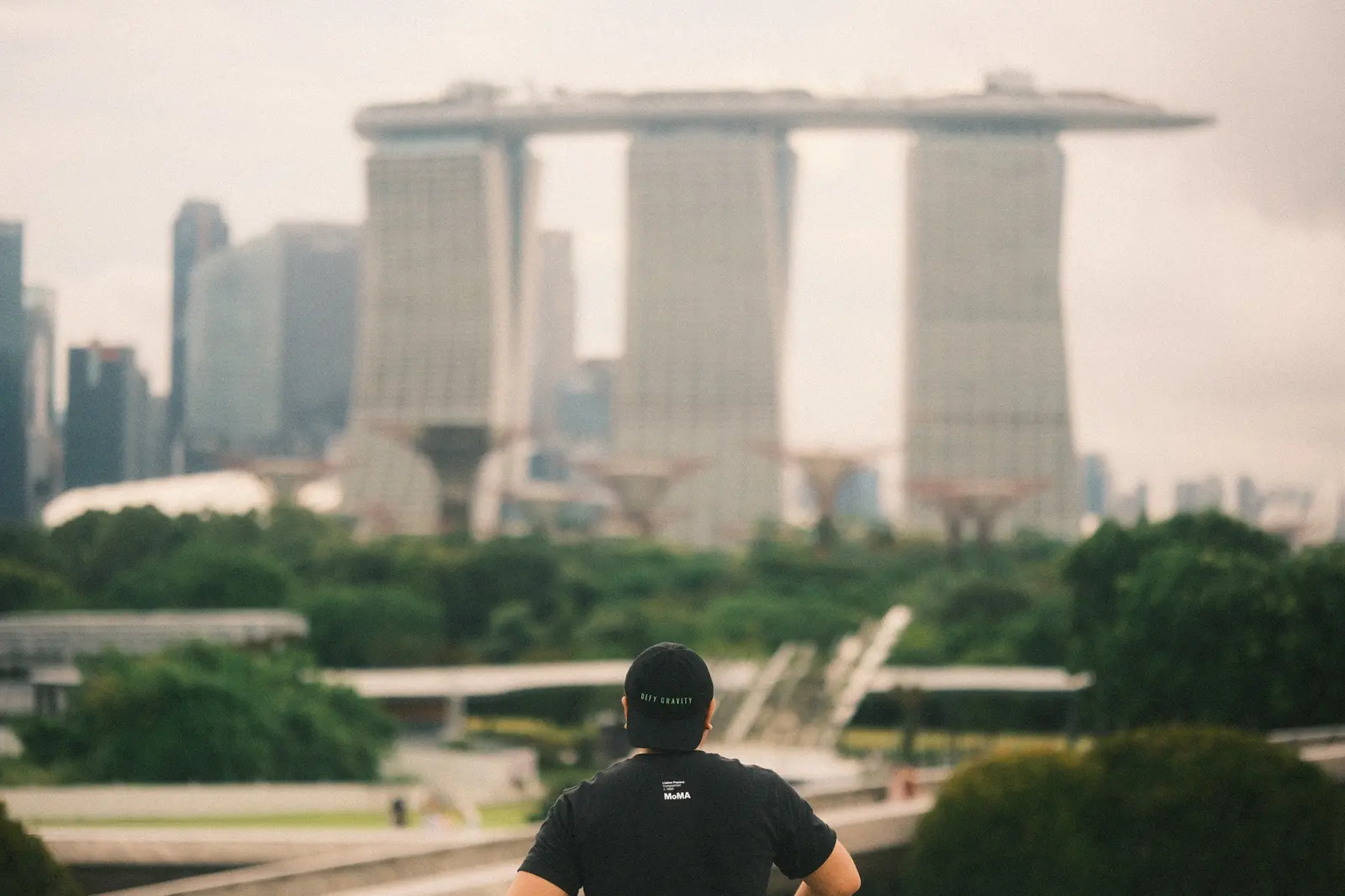 Archieval Mariano seen from behind, looking toward the Singapore skyline