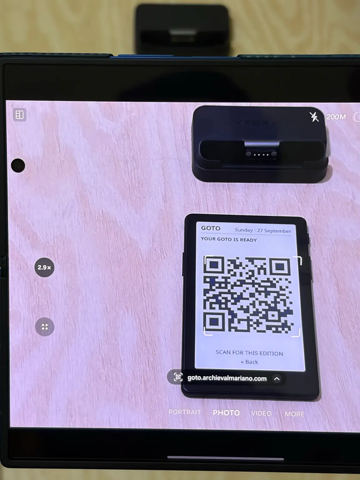 A Samsung Galaxy Z Fold 7 camera scanning the GOTO edition QR code on the X4 Pro and detecting goto.archievalmariano.com.