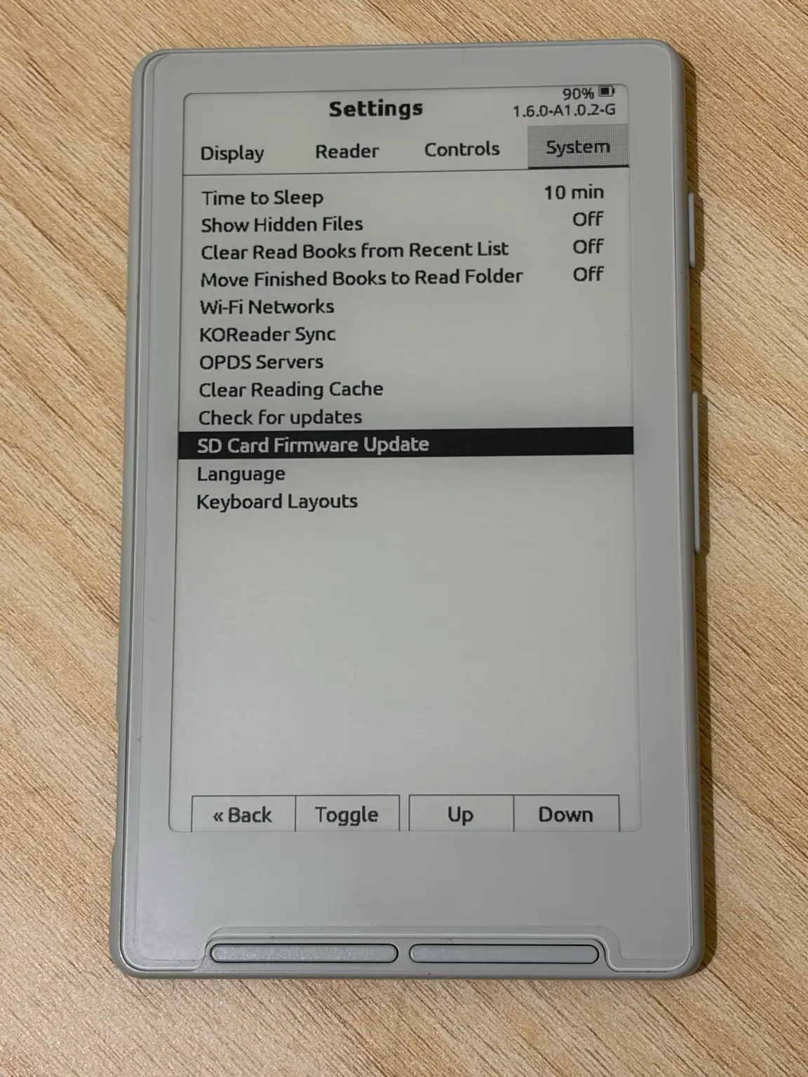 The XTEINK X4 Settings screen on the System tab, with SD Card Firmware Update highlighted and the version 1.6.0-A1.0.2-G in the header.