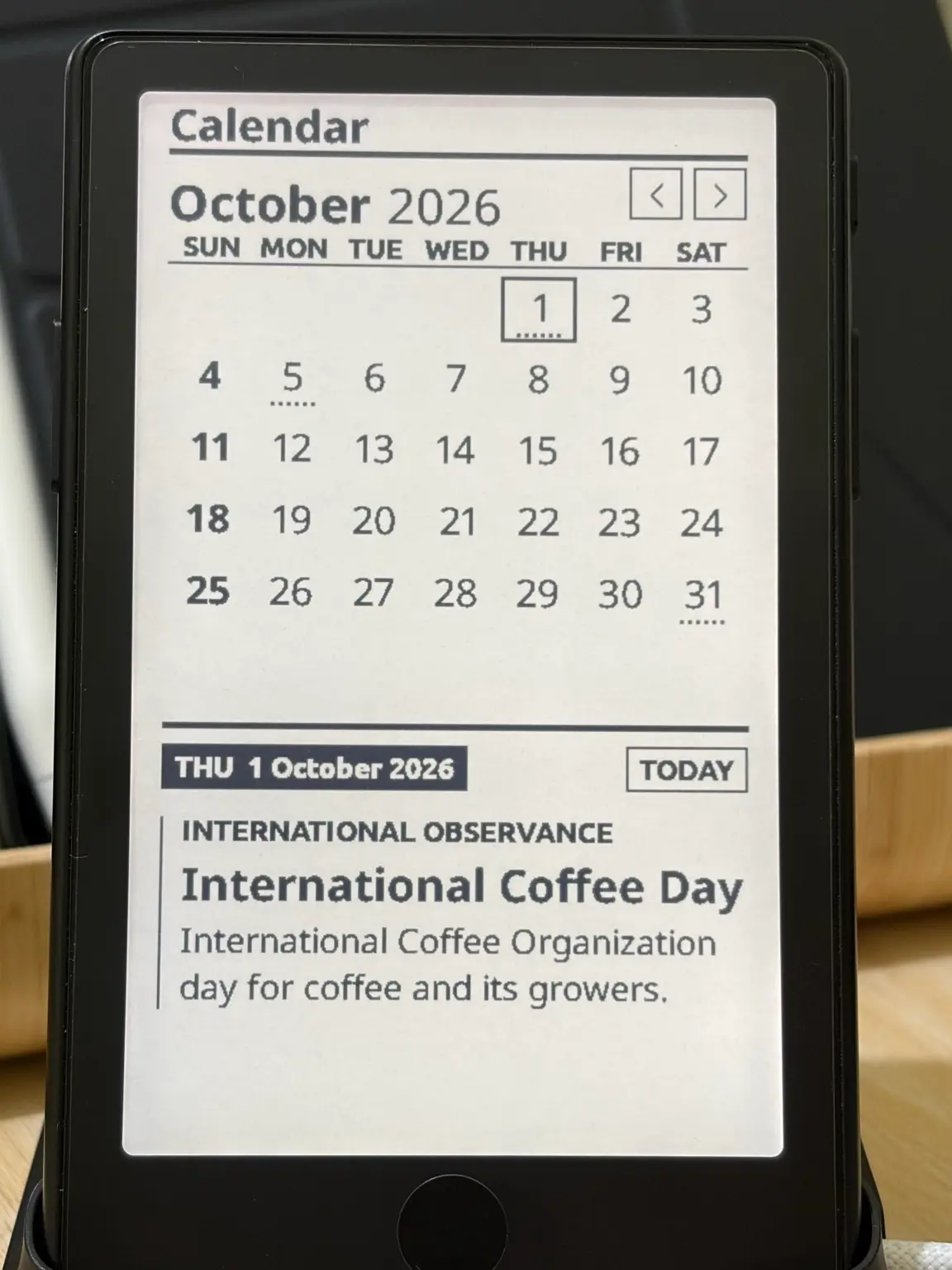 Calendar on an XTEINK X4 Pro showing October 2026, with 1 October marked International Coffee Day.