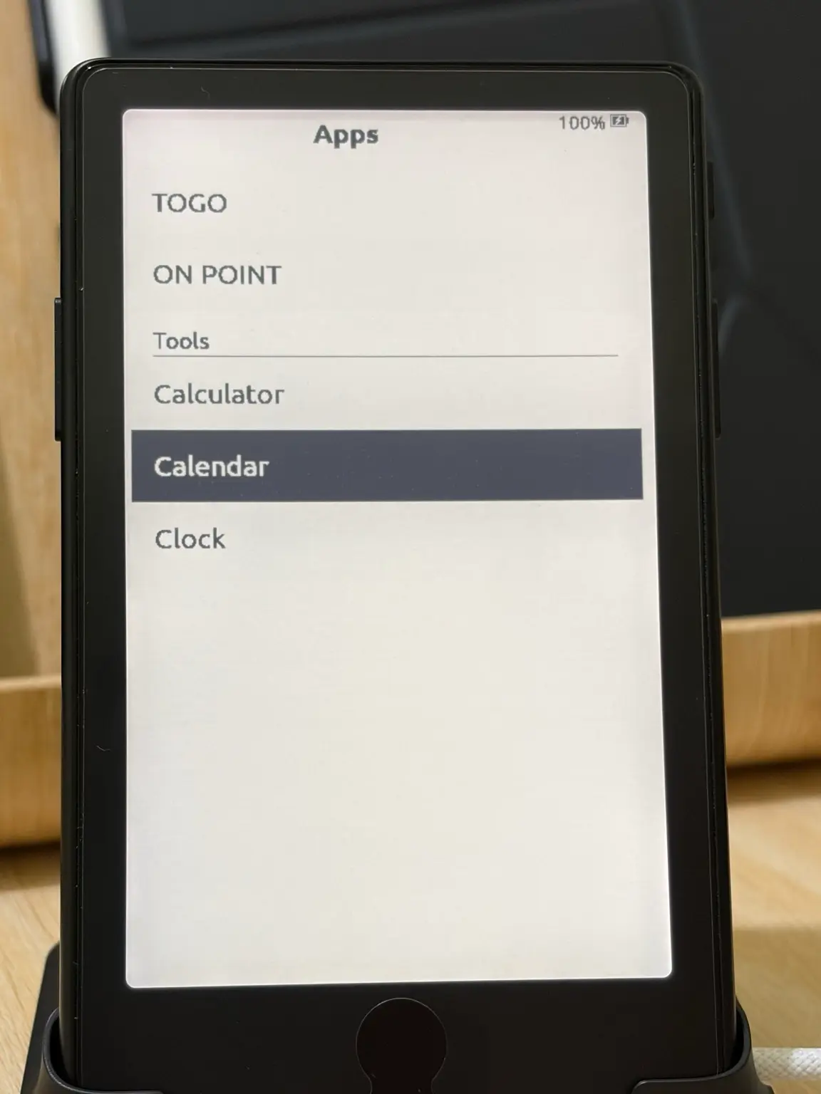 The CrossPoint Apps screen on an XTEINK X4 Pro listing TOGO and ON POINT, then a Tools heading above Calculator, Calendar and Clock.